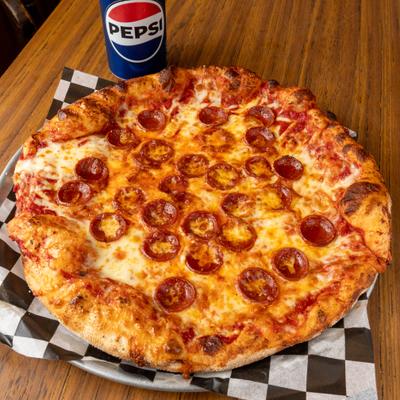 Pepperoni pizza served with a soda.