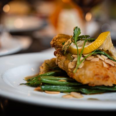 Fried fish fillet with green beans and almonds.