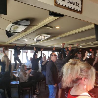 Crowded interior, customers cheering.