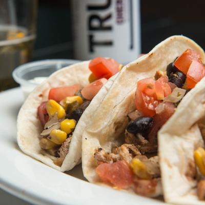 Chicken tacos, with tomato, black beans, jalapenos, and corn.