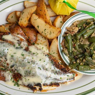 Blackened Redfish, Beurre Blanc Sauce served wuth New Potatoes & Rips Green Beans.