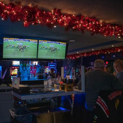 Customers watching a football game.