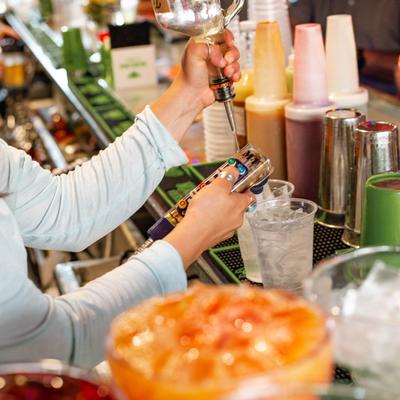 Close up of bartender pouring cocktails