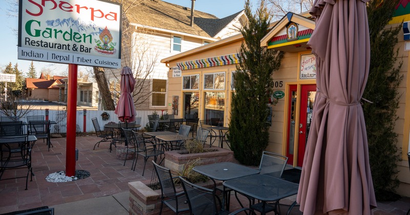 Exterior, outdoor seating area, tables for four and two people, stone paving