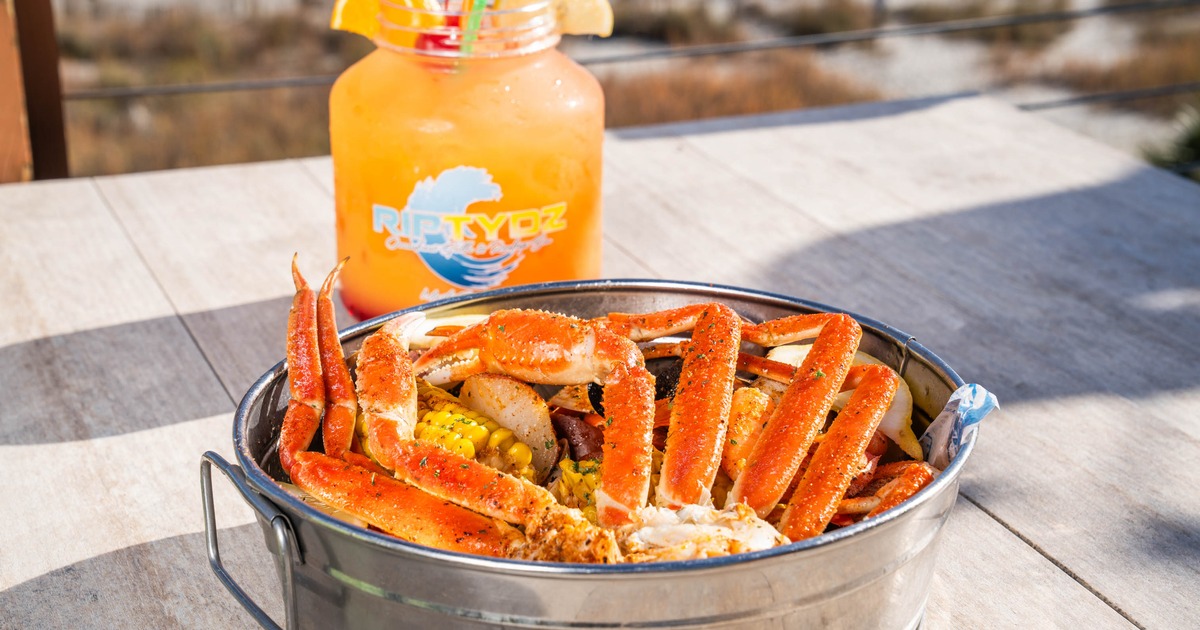 Portion of Snow Crab Legs served with a drink
