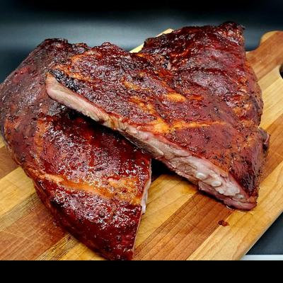 Ribs on a wooden cutting board.