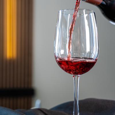 Red wine being poured into a glass.