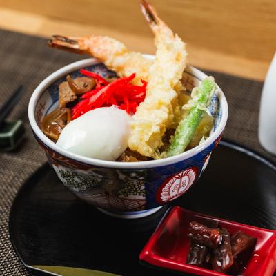 Slow cooked beef tendon  served with vegetables and fried prawns on top.
