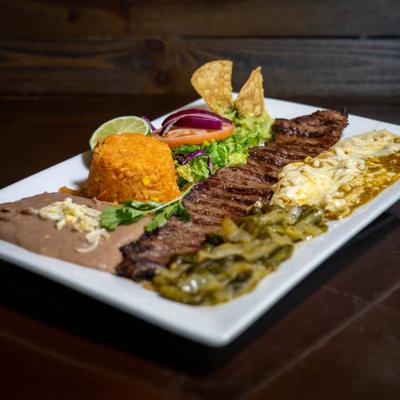 Charbroiled skirt steak with cheese enchilada.