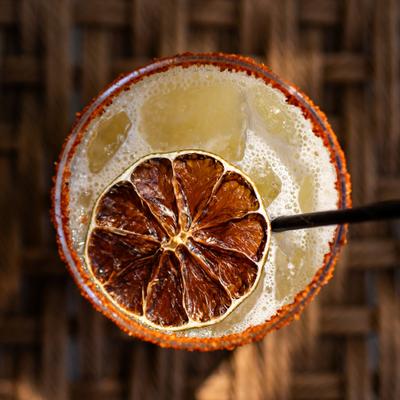 Georgian-flavored margarita cocktail from above with dried orange garnish