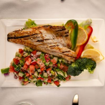 Branzino fillet with salad.