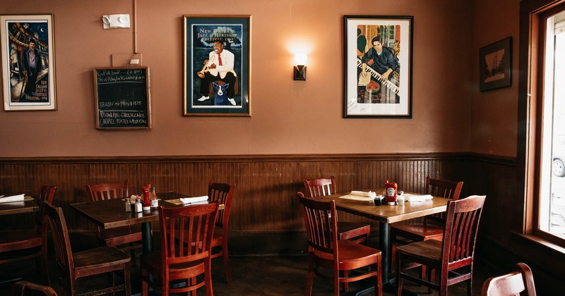 Interior, dining tables, framed pictures on a wall