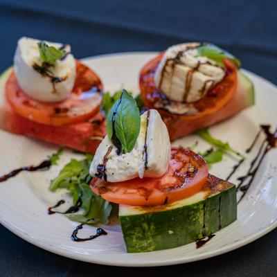 Caprese salad with slices of watermelon as a base.