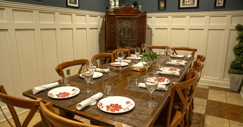 Interior, long table prepared for guests
