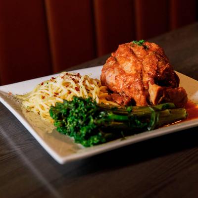 Braised and slow cooked veal shank, served with spaghetti and broccolini.