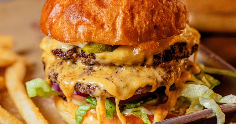 Close up of Eagle Classic Burger, served with fries