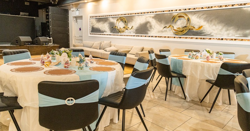 A luxurious banquet hall with set round dining tables