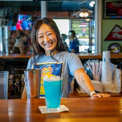 Bartender preparing drinks.