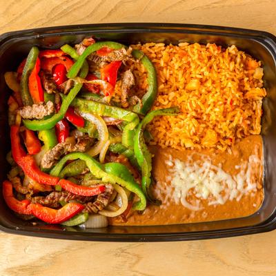 Steak fajitas with rice and refried beans in a takeout container, top view.