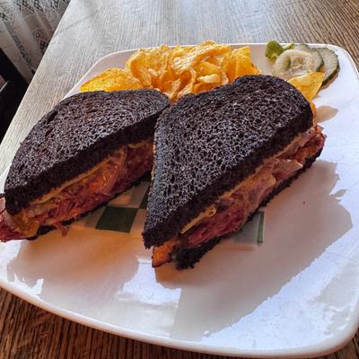 Reuben - Slow Roasted Corned Beef, Swiss Cheese, Sauerkraut and 1000 Island Dressing All On Toasted Black Rye.
