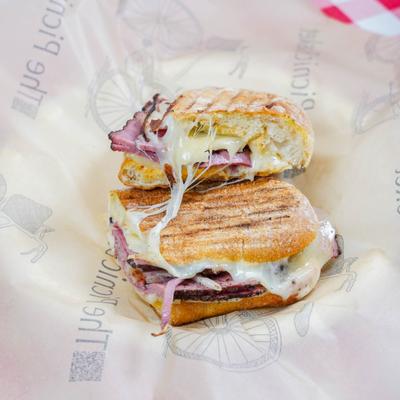 Pastrami sandwich with provolone, sautéed onions and pickled jalapeños.