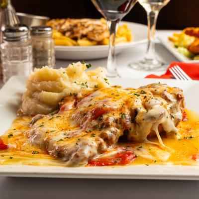 Cheese-covered chicken served with a side of mashed potatoes
