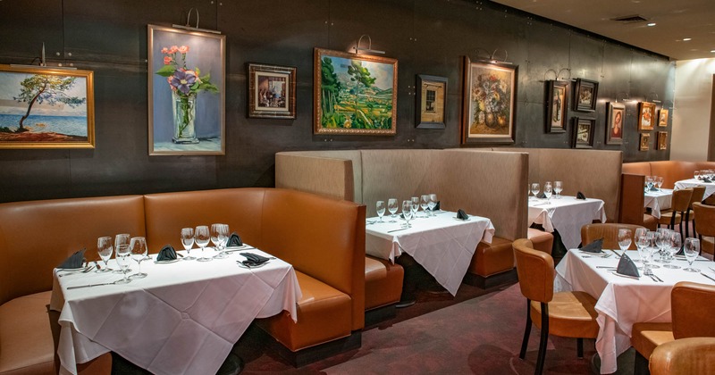 Inside, booth seating area, with paintings on the wall
