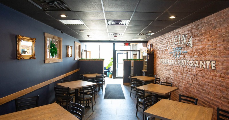 Interior, dining tables with chairs, logo and mirrors on the walls