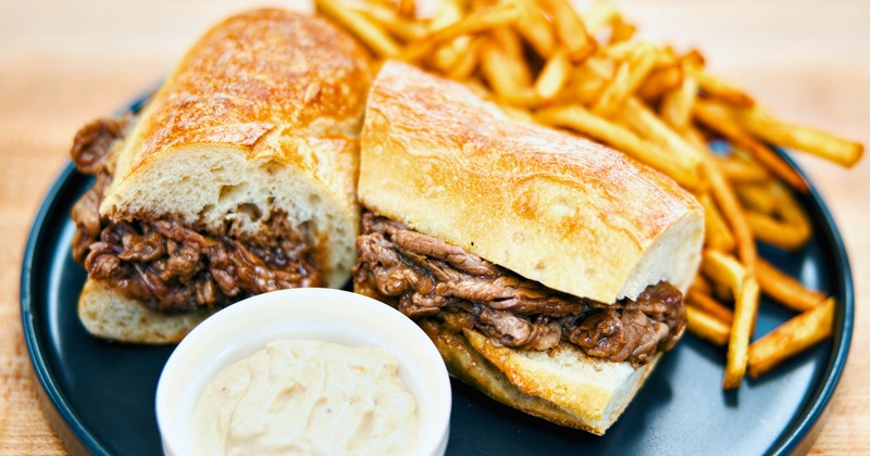 Steak Sandwich served wth fries and sauce on the side