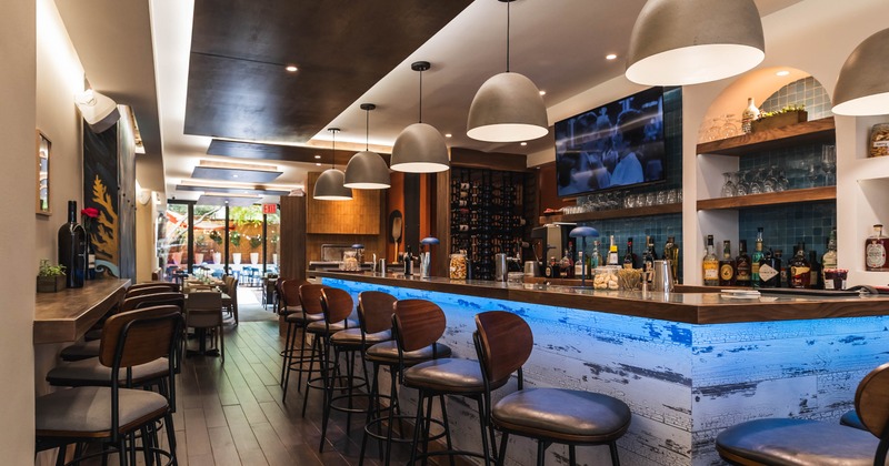 Interior, seating area with a bar and bar stools