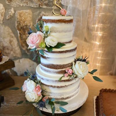 Four tier naked cake, decorated with white and pink roses