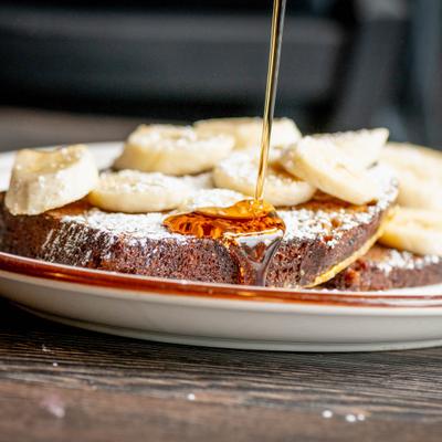 French toast with banana slices and syrup.