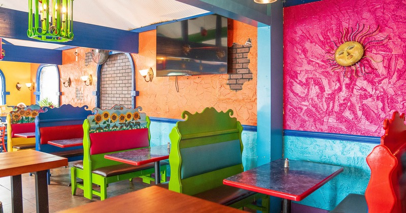 Interior, dining booths near colorful walls