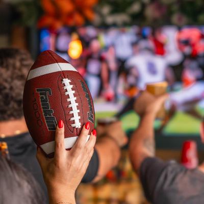 Customer holding a football.