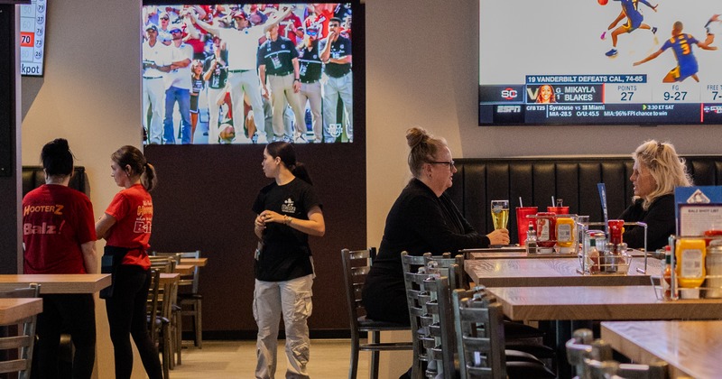 Interior, diner area, tables, chairs, screens, people