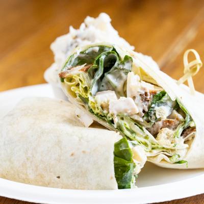 Chicken caesar wrap cut in half, close-up.