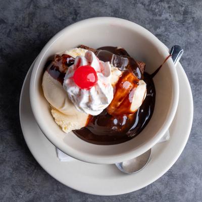 Ice cream sundae with chocolate sauce and a cherry.