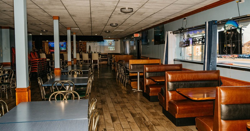Interior, tables and chairs on the left, tables and seating booths on the right