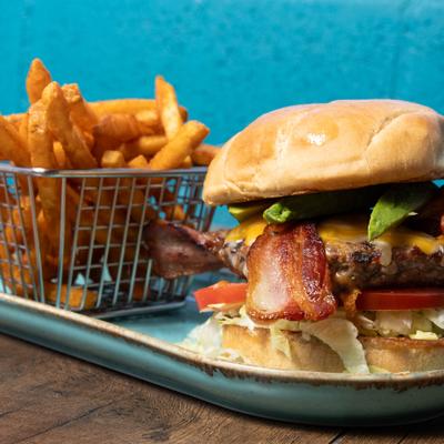 California Burger served with fries in a metal wire basket.