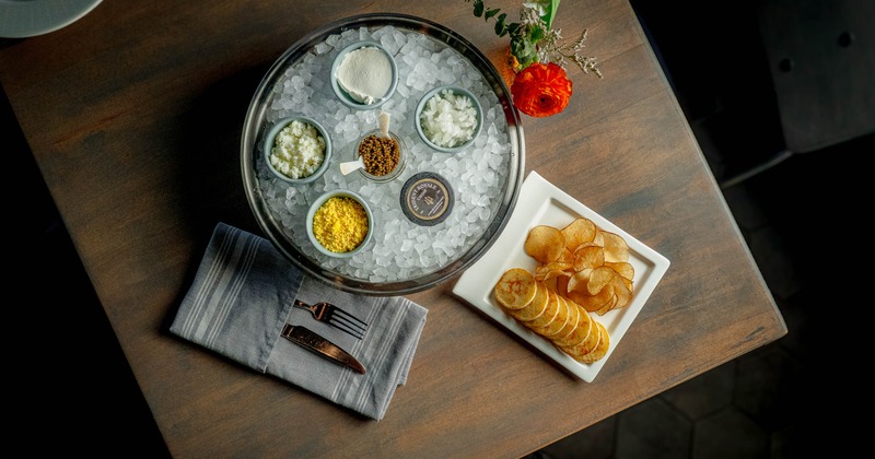 Caviar on ice with garnishes and chips