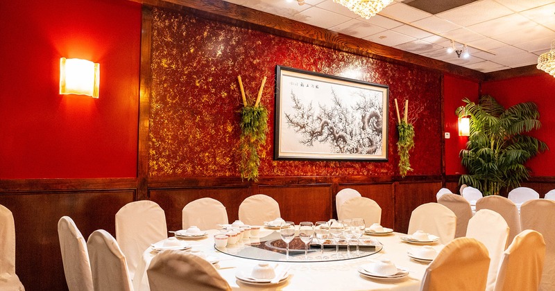 Chinese round dining table with tableware, glasses and accessories ready for guests