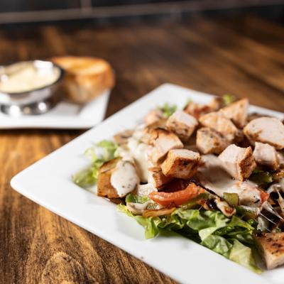 Hot Italian Salad, served on the table with two dips on the side.