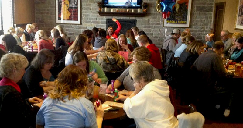 Crowded restaurant with people enjoying food and drinks