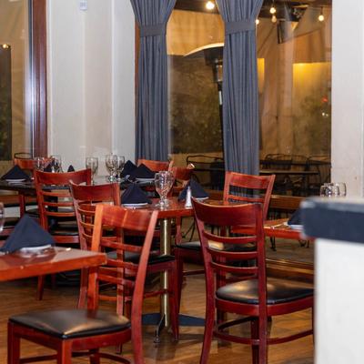Interior, wooden tables with tableware ready for guests