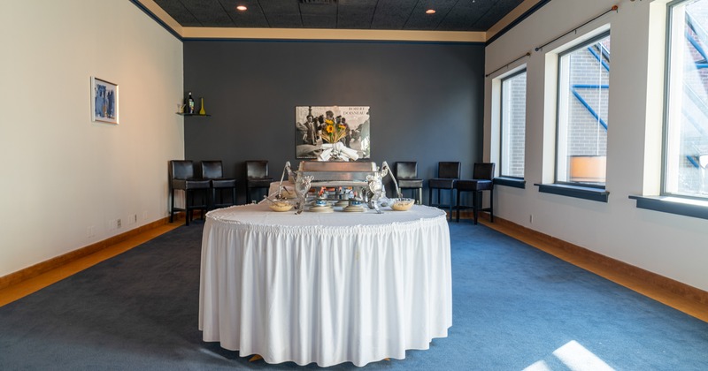 Interior, skirted table with chafing dish and served food bowls