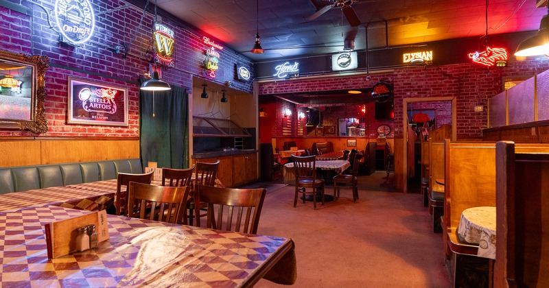 Spacious dining area with wooden tables and chairs and retro decorations