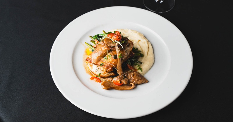Grilled chicken with mashed potatoes, greens, and mushrooms