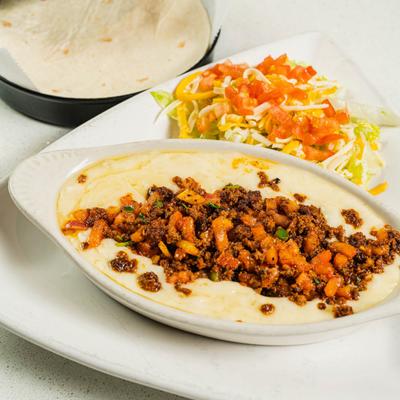 Queso topped with chorizo, served with salad  and tortillas