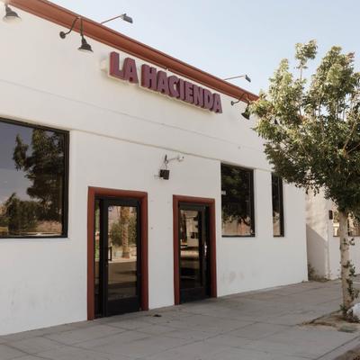 La Hacienda restaurant storefront with signage and glass doors.