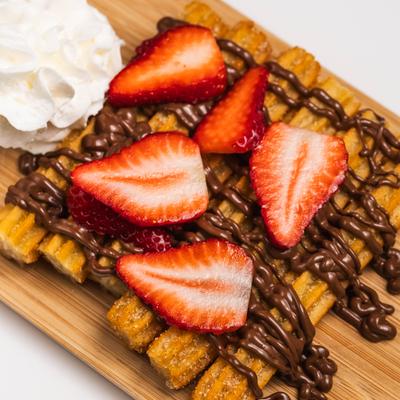 Churros with Nutella, strawberries, and ice ream.